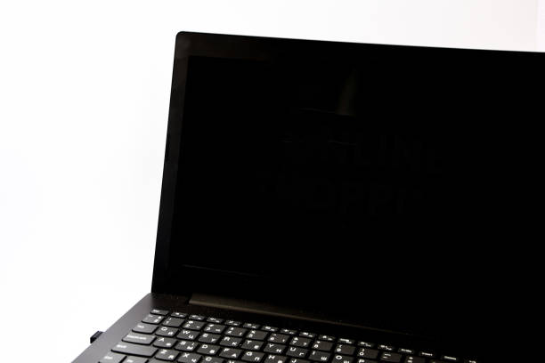 istock Sleek modern laptop with blank black screen, front view and isolated on white background with reflection 1207972537