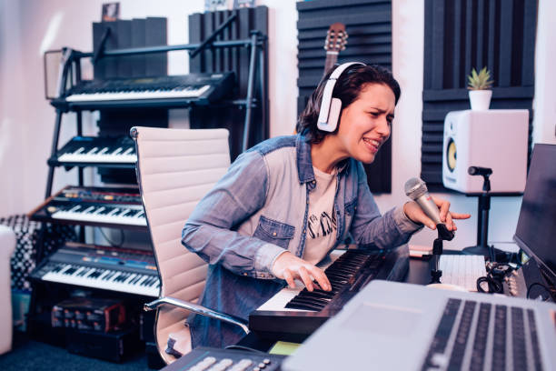 istock Young musician recording music in the studio 1207972661
