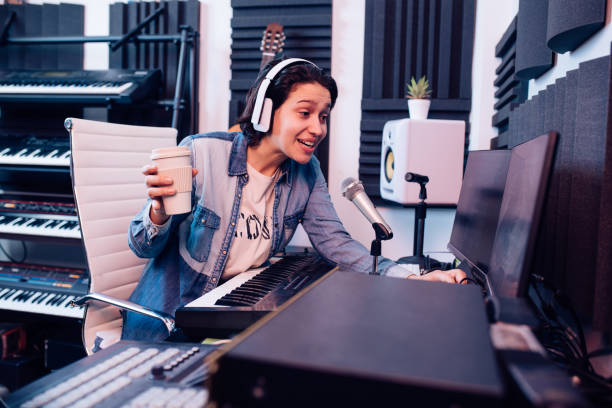istock Singer drinking coffee and working in the music studio 1207972664