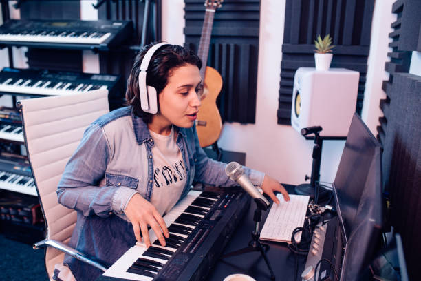istock Girl recording music in the studio 1207972665