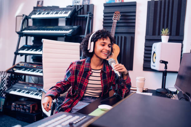 istock Young musician recording a song in the studio 1207972688