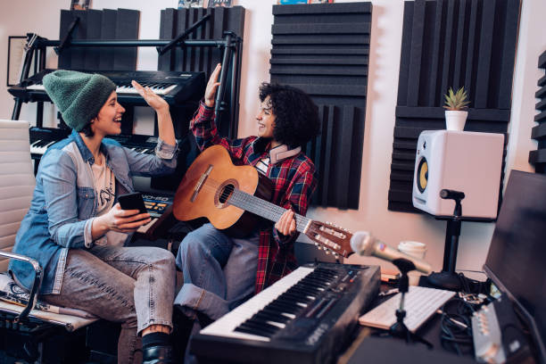 Two female musicians celebrating the making of their new song
