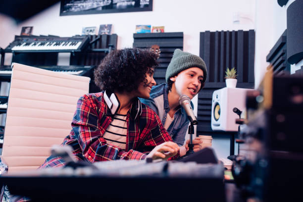 istock Two musicians working in the music studio together 1207973230
