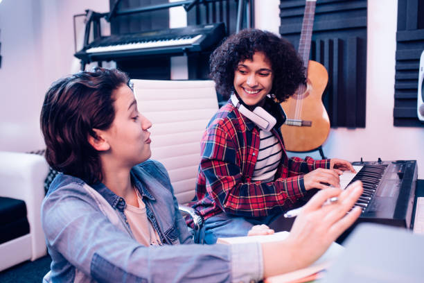 istock Two young musicians cooperating and making music together 1207973233