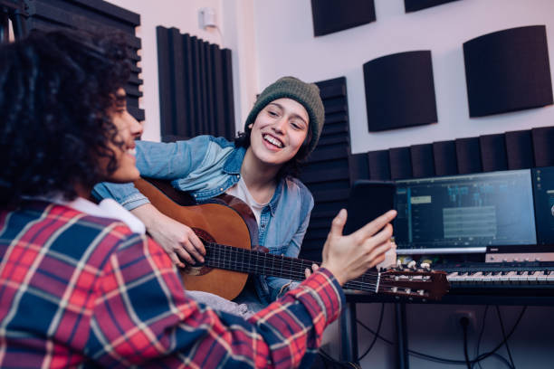 istock Two musicians recording music in the studio 1207973234