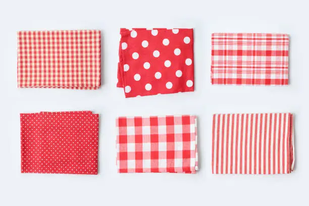 Photo of Red tablecloth or kitchen towel collection on white background. Cooking or baking mock up for design.