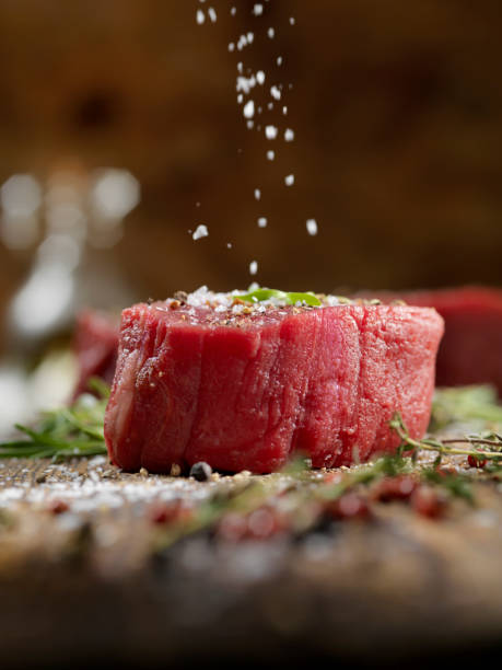 Seasoning Raw Fillet Mignon Steaks Seasoning Raw Fillet Mignon Steaks steak vertical beef meat stock pictures, royalty-free photos & images
