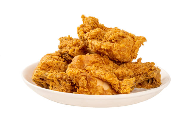 chiudi i polli fritti su piatto bianco isolato sul tavolo. guarda il colore oro gustoso e giallo. - pollo fritto foto e immagini stock