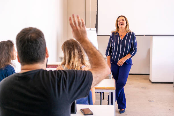 istock Group of students and a teacher in a classroom. 1207978018