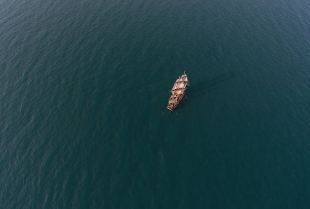 Retro sailing ship in open sea. Aerial top view stock photo
