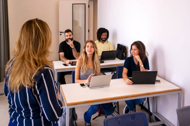 istock Group of students and a teacher in a classroom. 1207978131