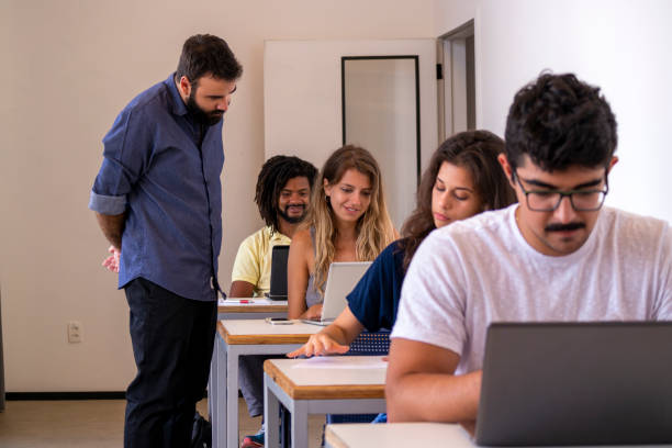 istock Group of students and a teacher in a classroom. 1207979061
