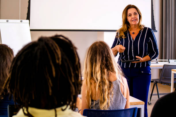istock Group of students and a teacher in a classroom. 1207979191