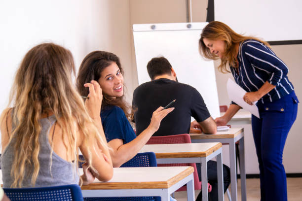 istock Group of students and a teacher in a classroom. 1207979475