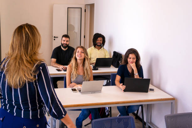 istock Group of students and a teacher in a classroom. 1207979532