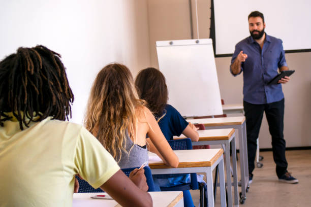 istock Group of students and a teacher in a classroom. 1207979605