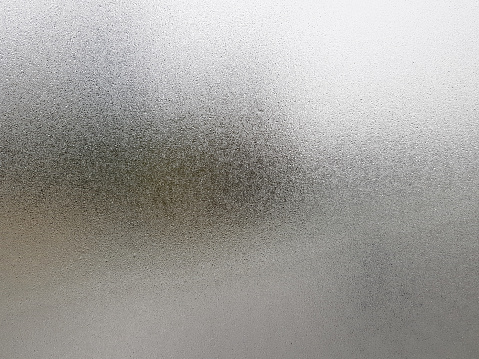Transparent glass with fog up and water drop on it during winter season. Close up shot of Natural beauty effect. Background and wallpaper concept.