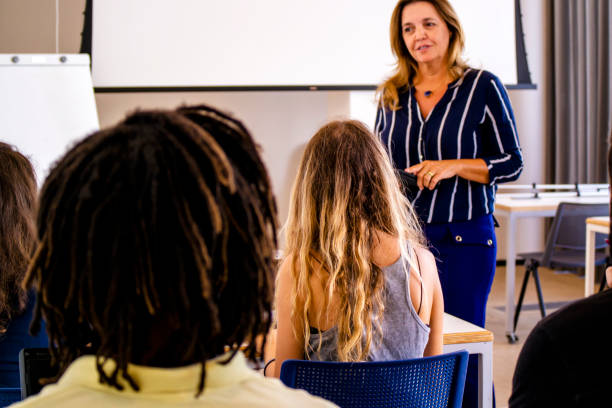 istock Group of students and a teacher in a classroom. 1207980376