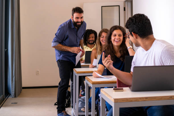 istock Group of students and a teacher in a classroom. 1207981411