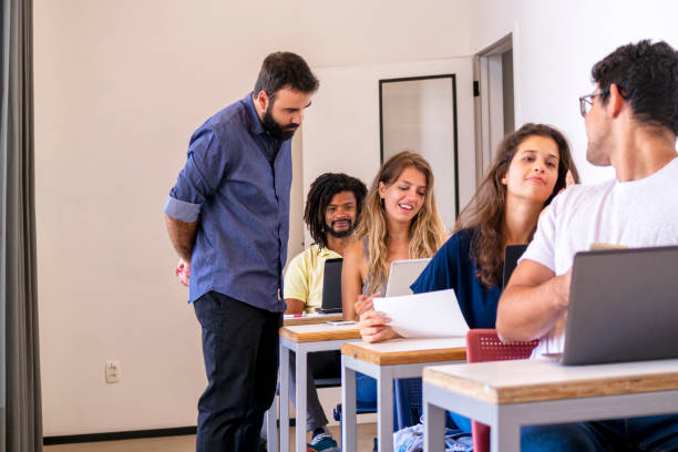 istock Group of students and a teacher in a classroom. 1207981484