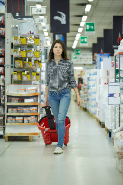 istock Pretty woman buy at hardware store 1207981524