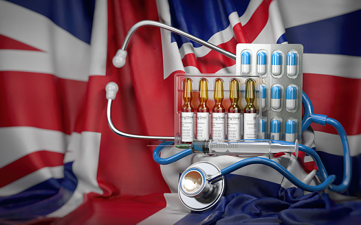 Healthcare, insurance and pharmacy in USA concept. Pills, vaccine, syrringe and stethoscope in UK flag. 3d illustration