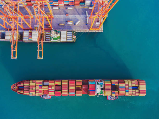 Aerial view of freight ship with cargo containers in Istanbul Large transport ship and view of the harbor. High angle view on Cargo crane container terminal cargo container shipping harbor trading stock pictures, royalty-free photos & images