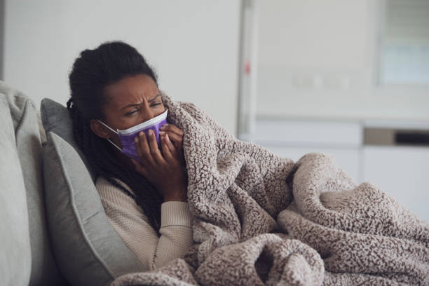 istock Woman coughing, lying down and resting. 1207990863