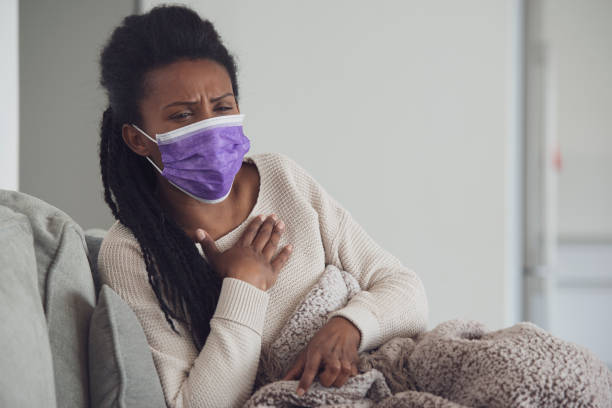 istock Ill woman coughing lying down and resting. 1207992692