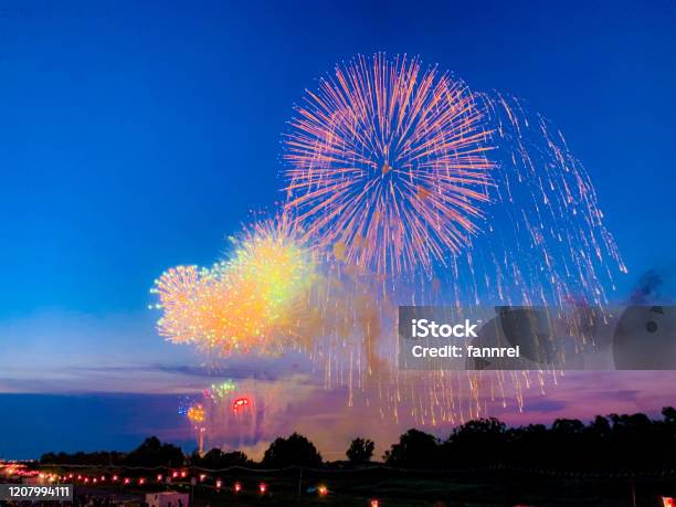 Beautiful Colorful Fireworks Against Blue Sky Stock Photo - Download Image Now - Abstract, Anniversary, Backgrounds