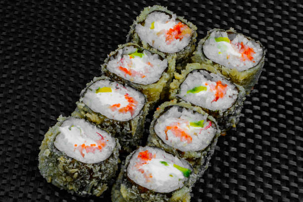 istock Japanese rolls on a dark textured background 1207996880