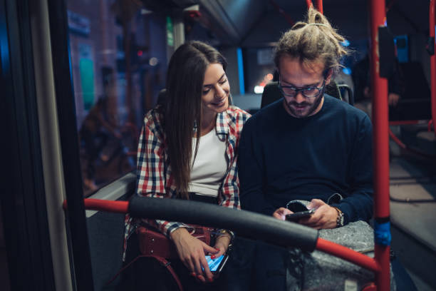 istock Friends surfing the net in bus 1207996950