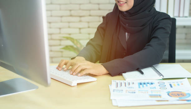 Young beautiful asian muslim business woman wearing black hijab,working at coworking place. Young beautiful asian muslim business woman wearing black hijab,working at coworking place. arabian girl stock pictures, royalty-free photos & images