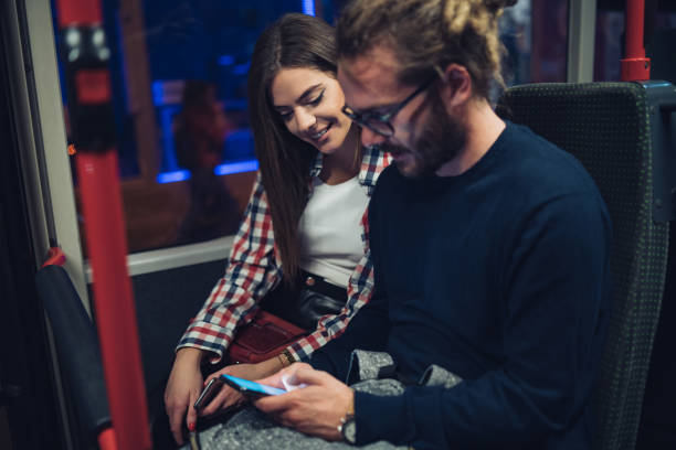 istock Friends surfing the net in bus 1207997814