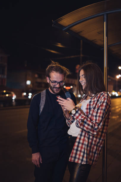 istock Friends using cellphones in the street 1207997846