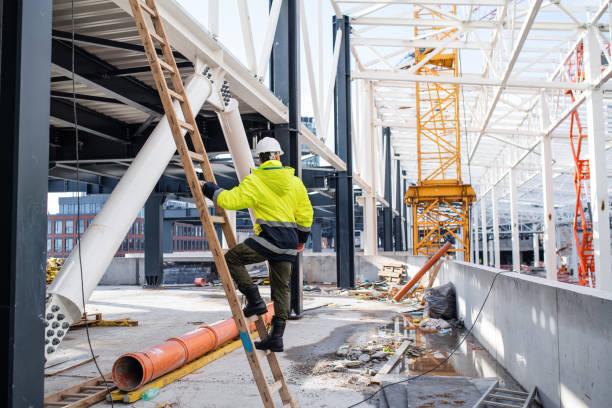 istock Rear view of man worker outdoors on construction site, working. 1207998393