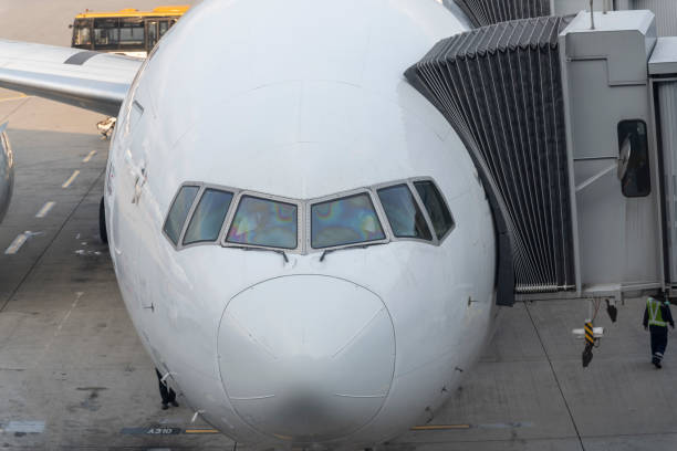 istock Close front outside view of a white jet plane cockpit 1207999137