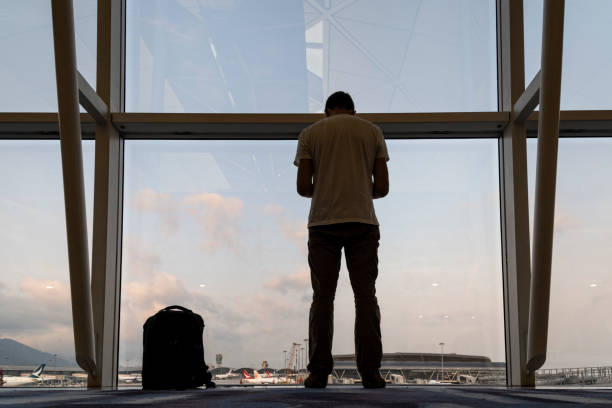 istock Silhouette of a tourist waiting for a flight 1207999215