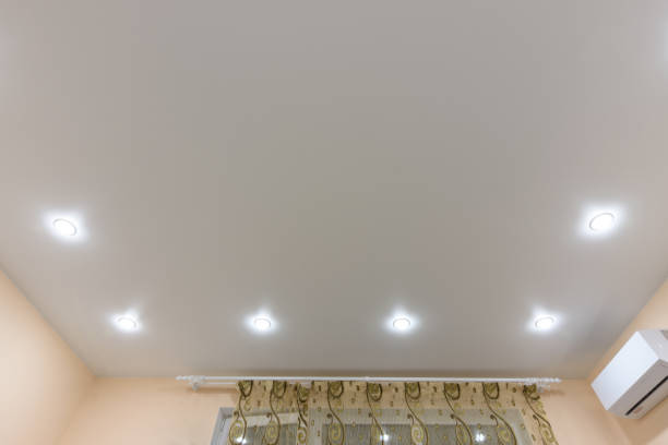 istock Light bulbs located on the perimeter of the stretch ceiling 1208000916