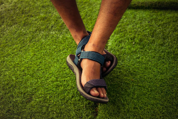 the man feet wearing sport sandals. selective focus stock photo