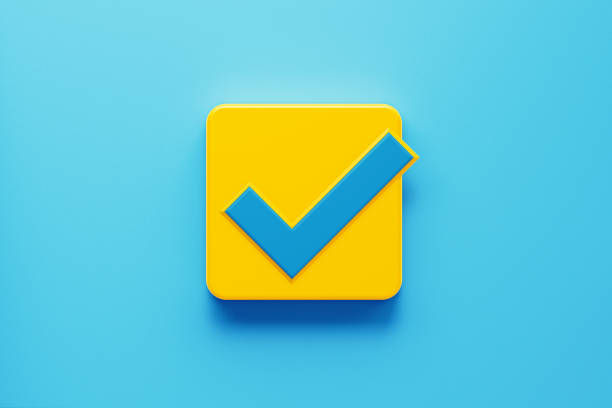 Yellow Push Button with Check Mark Symbol Yellow computer button with blue check mark symbol on blue background. Horizontal composition with copy space. Control concept. permission concept photos stock pictures, royalty-free photos & images