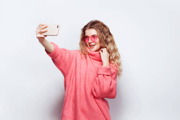 istock Lovely woman with smartphone taking a selfie 1208012664