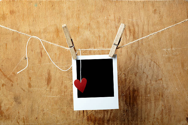 istock Blank picture frame and small heart hanging on clothesline 120801282