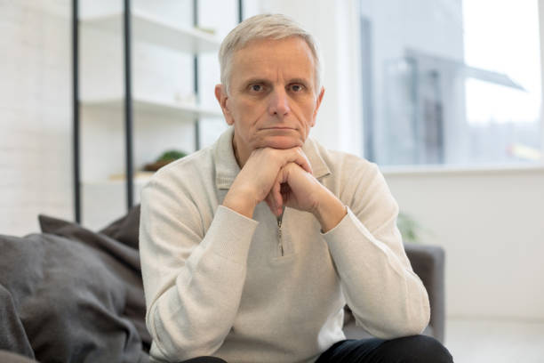 istock Upset mature man looking at camera at home 1208013817