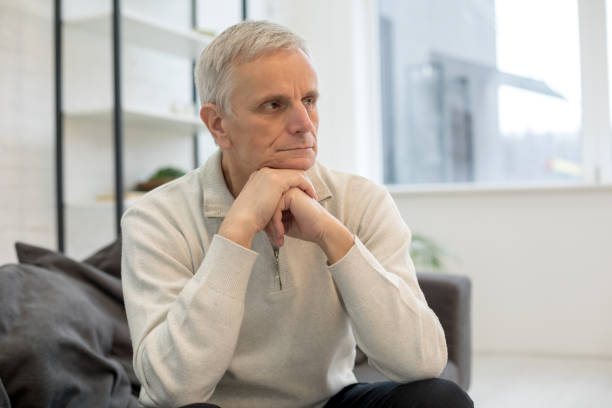 istock Upset mature man looking at camera at home 1208013885