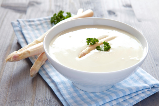 fresh asparagus soup in a bowl with parsley