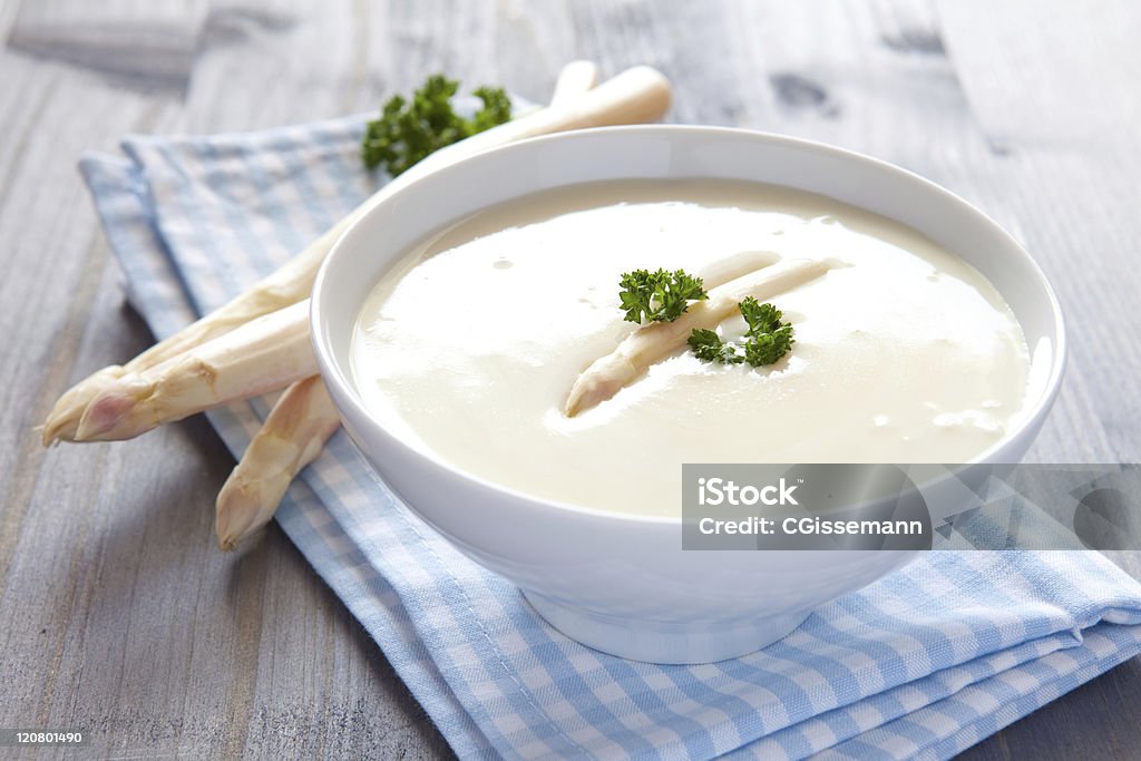 fresh asparagus soup fresh asparagus soup in a bowl with parsley Asparagus Stock Photo