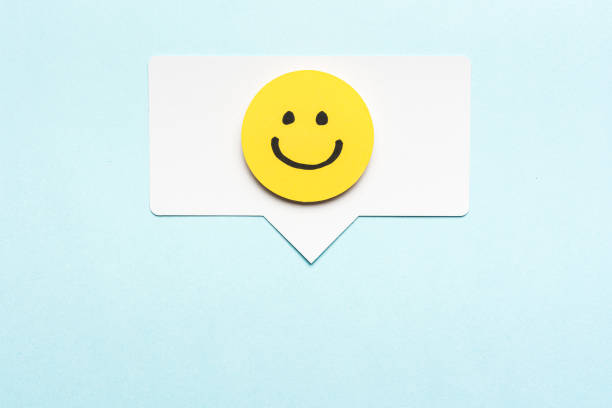 Happy face emoticon smiling comment on speech bubble and blue background. Social media marketing concept. Happy face emoticon smiling comment on speech bubble and blue background. Social media marketing concept. anthropomorphic smiley face photos stock pictures, royalty-free photos & images