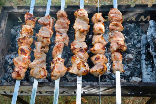 istock Marinated shashlik preparing on a barbecue grill over charcoal. 1208017815