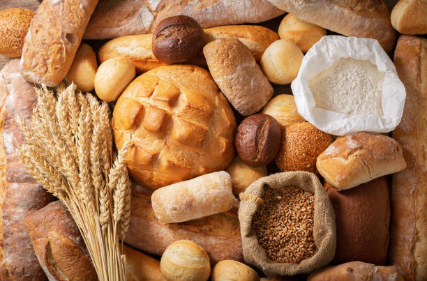 istock Fresh baked bread and wheat ears, top view 1208018757